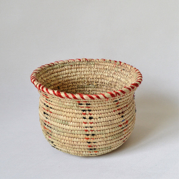 Wide woven bowl decorated with red and black fabric