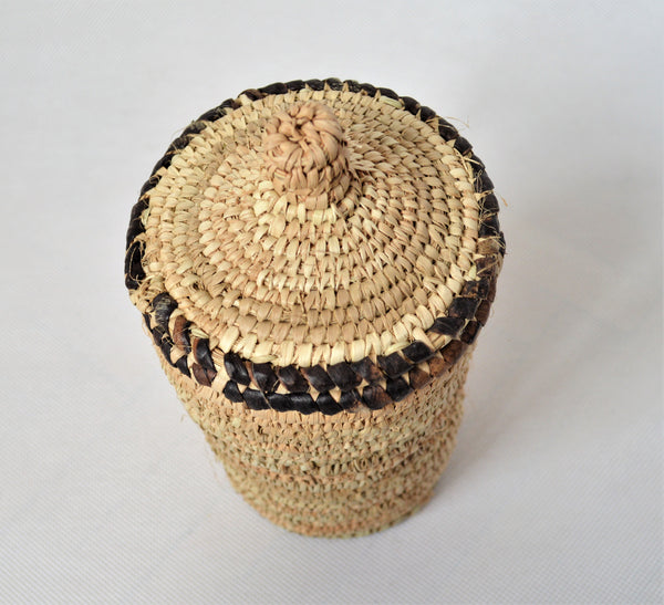 Long woven container lidded with true leather decoration