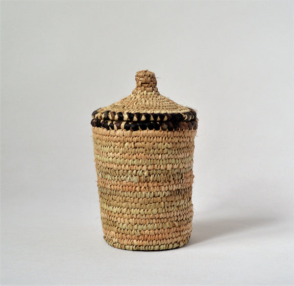Long woven container lidded with true leather decoration